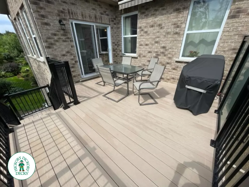 High rise Azek deck in beige color with unique steps and black railing.