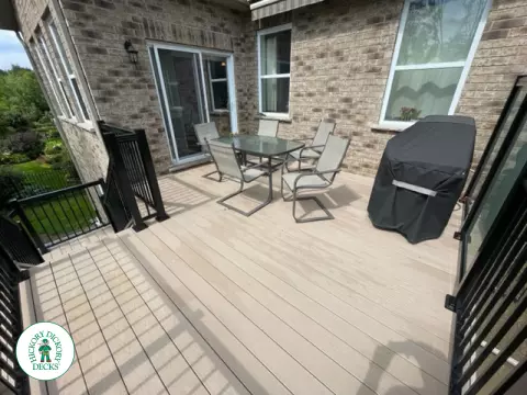 High rise Azek deck in beige color with unique steps and black railing.