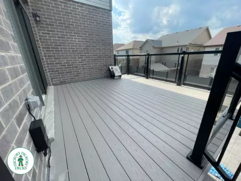 High grey composite deck with glass style railings.