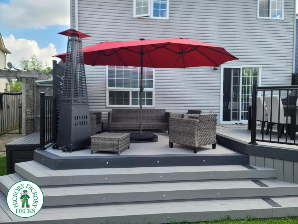 Trex deck in grey color with wrap around stairs, lights in steps.