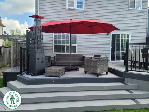 Trex deck in grey color with wrap around stairs, lights in steps.