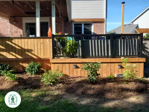 Cedar deck with roof structure that has a built in bar, and aluminum railings with a gate insert.