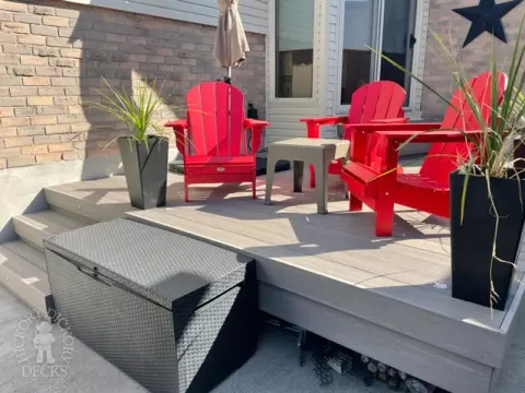 Small grey azek walk out deck with lighting in stairs