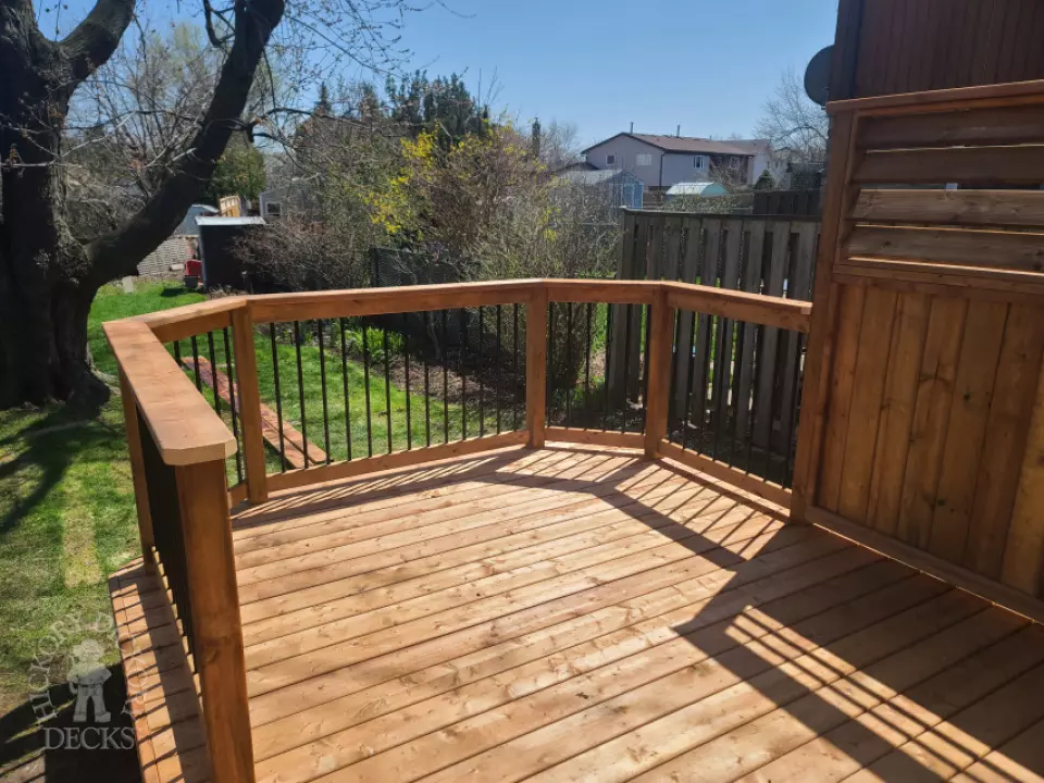 Low cedar deck with picket cedar railings and a cedar privacy screen.