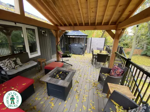 Mid-high deck brown TruNorth deck with lighting in steps and black aluminum railing all around.