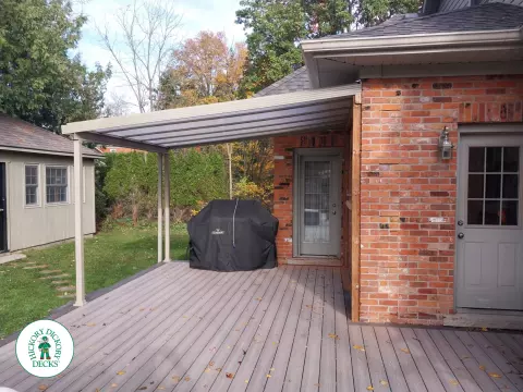 Grey deck with dark grey trim and a sunspace roof structure.