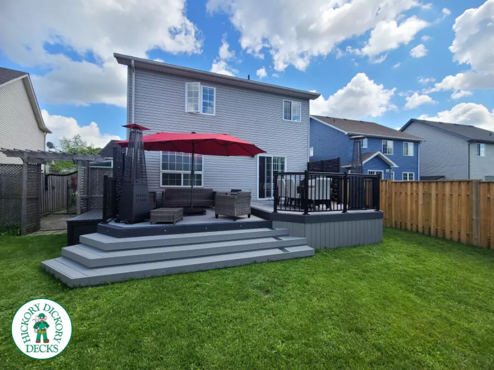 Trex deck in grey color with wrap around stairs, lights in steps.