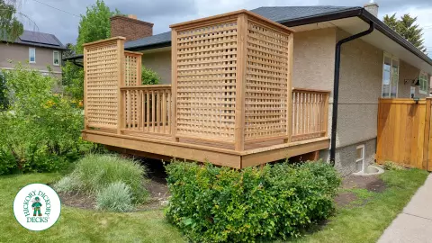 Small pressure treated deck with pressure treated privacy screens and railing.