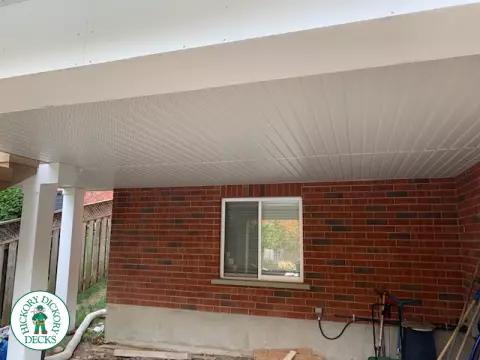 High composite deck with stairs that lead to pool and glass style railings.