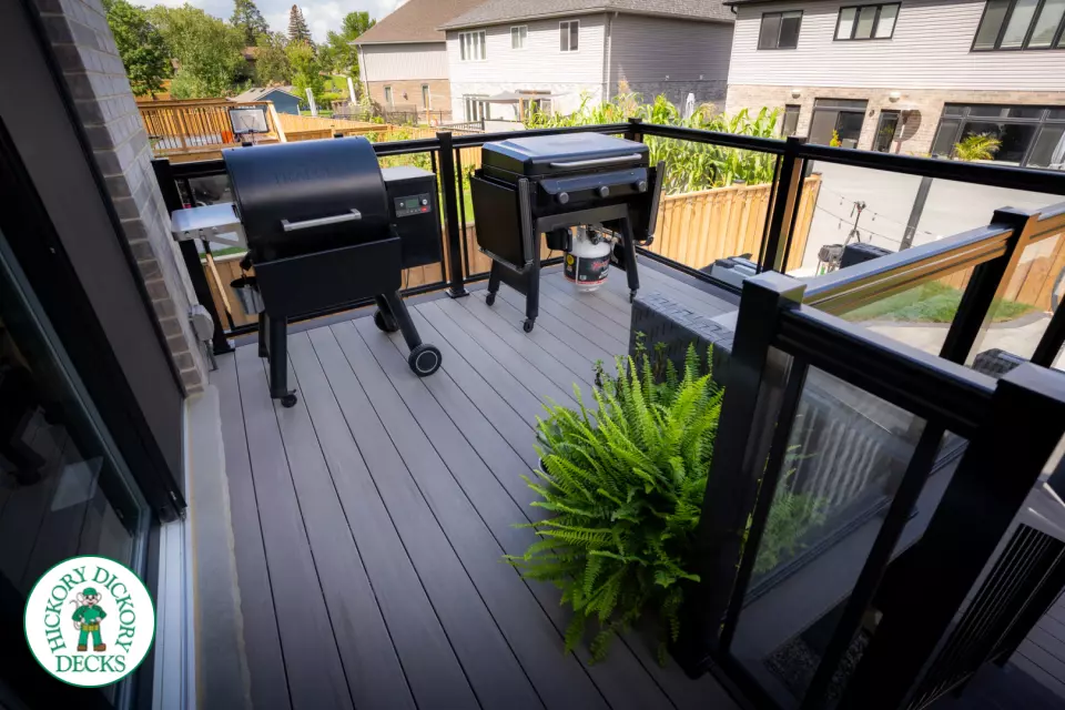 2 level brown composite deck with unique stairs and black aluminum railing. in Waterloo