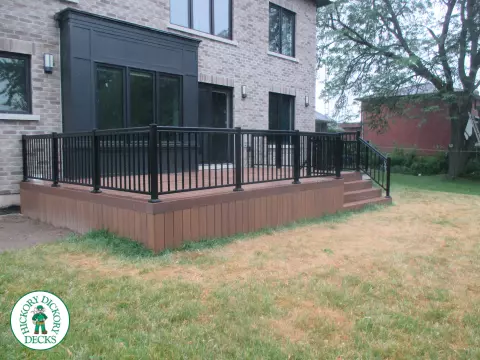 Low brown composite deck with black aluminum railing