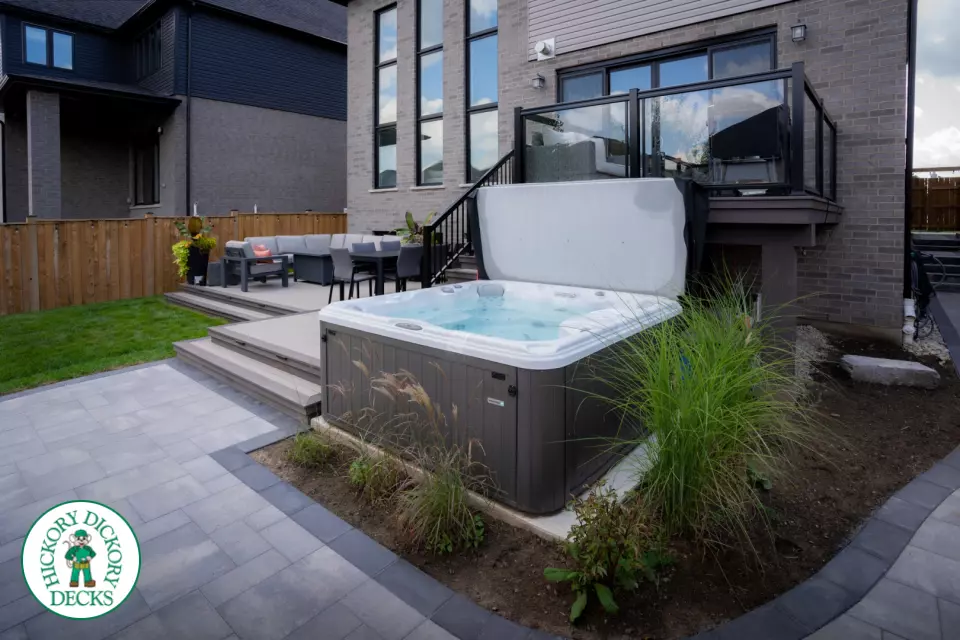 2 level brown composite deck with unique stairs and black aluminum railing. in Waterloo