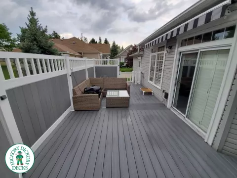 Private grey walk out deck with grey privacy screen all around