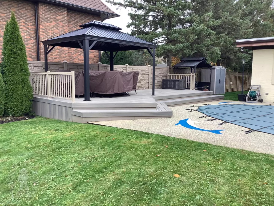 Grey pool deck with curved steps.