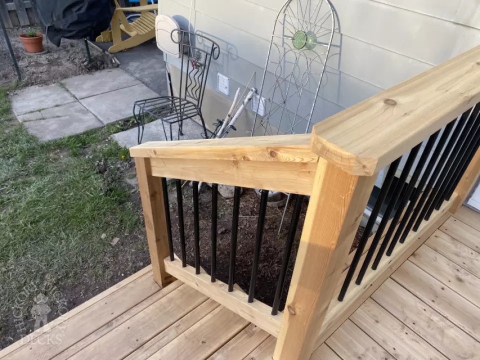 mid size walkout cedar deck with cedar picket railing