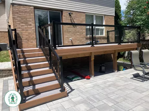 Veka modern deck in Mississauga with glass rails and stairs