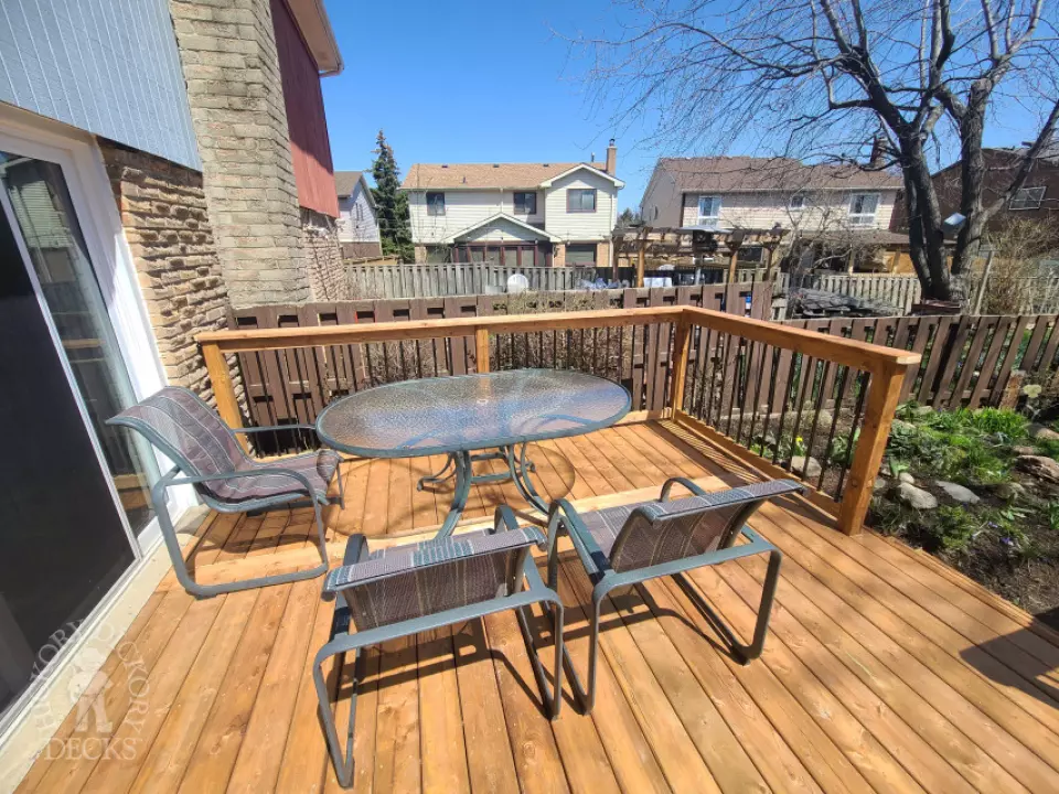 Low cedar deck with picket cedar railings and a cedar privacy screen.