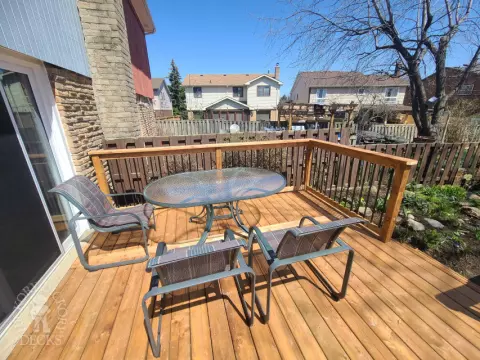 Low cedar deck with picket cedar railings and a cedar privacy screen.