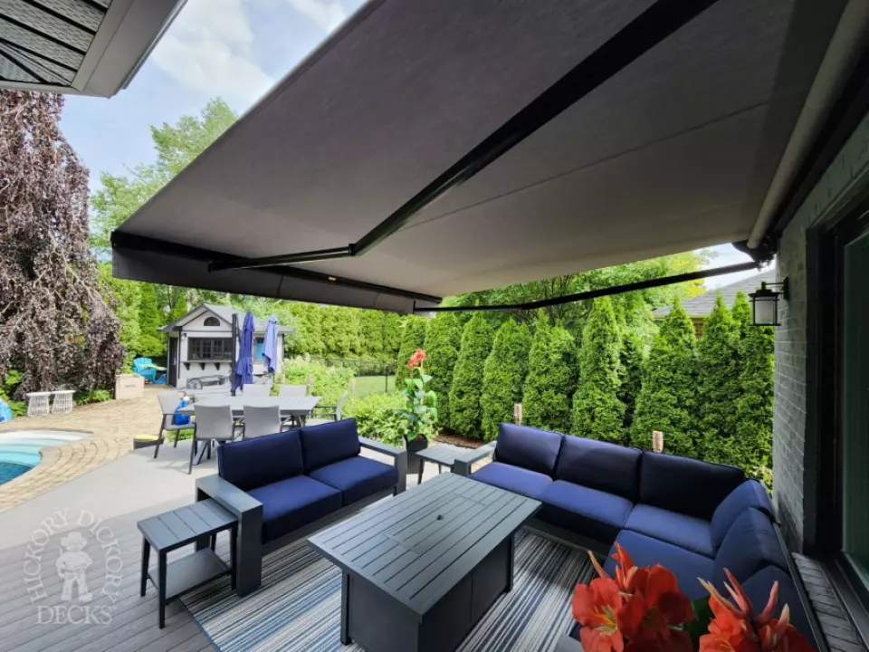 Large grey fiberon deck with a Rolltec awning Large grey fiberon deck with a Rolltec awning