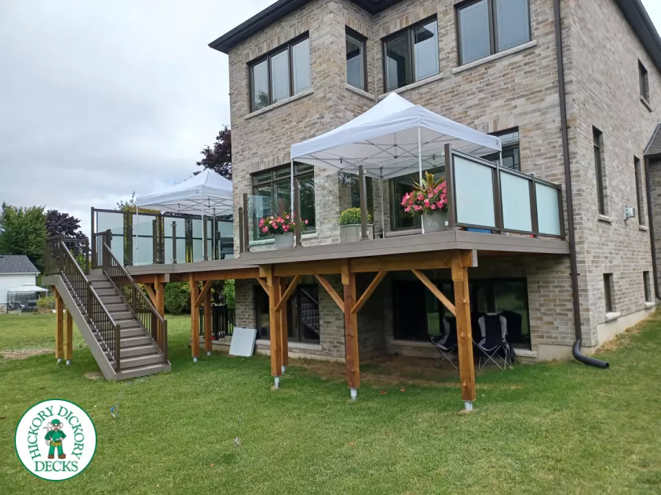 High grey composite deck with glass style railings.