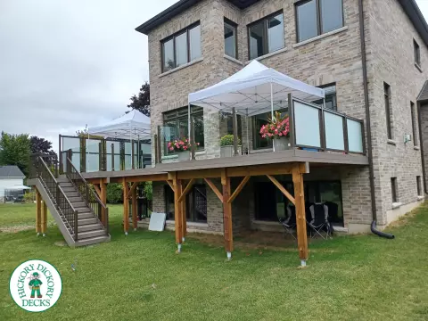 High grey composite deck with glass style railings.