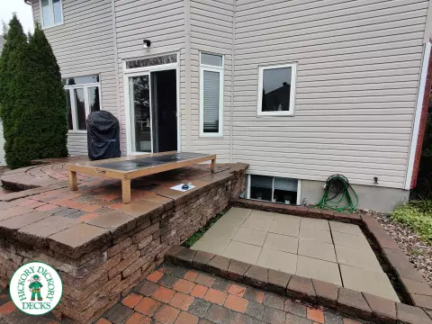192 square foot fiberon in brown with three steps up to deck and black aluminum railing.