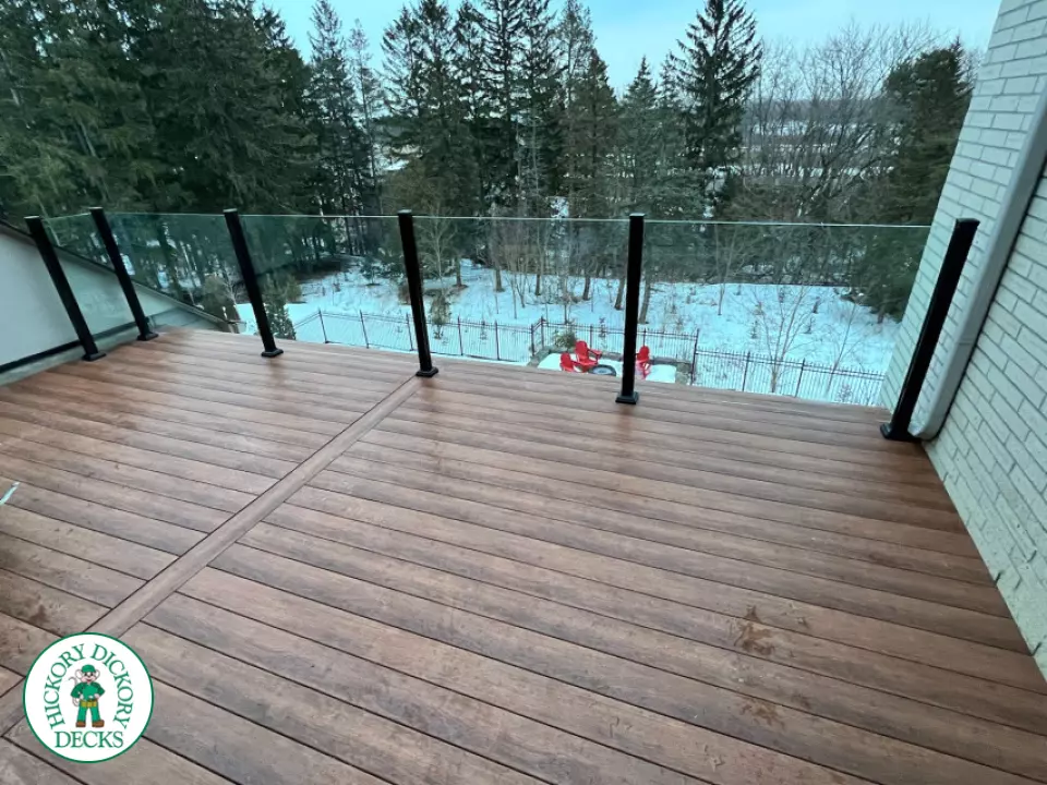 High brown composite deck with glass railings