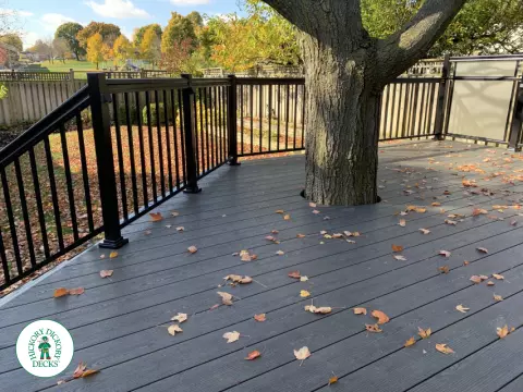 Clubhouse deck in colour driftwood built around a tree featuring: aluminum railings and frosted glass privacy screens, Mississauga, Ontario