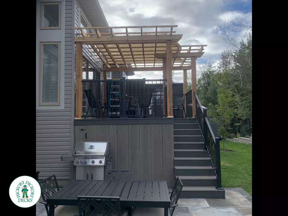 Mid high clubhouse deck with cedar pergola and a dark grey border.