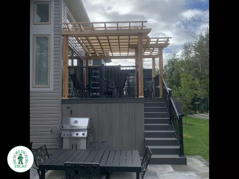 Mid high clubhouse deck with cedar pergola and a dark grey border.