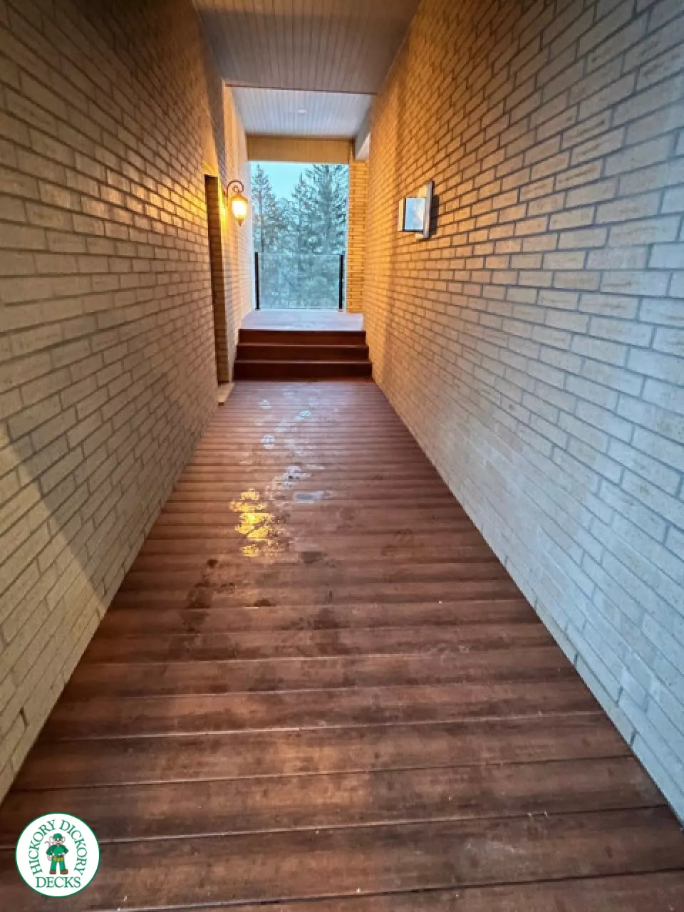 High brown composite deck with glass railings