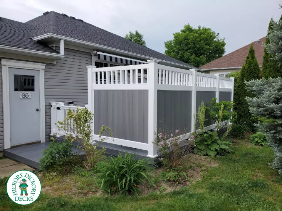 Private grey walk out deck with grey privacy screen all around