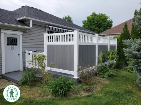 Private grey walk out deck with grey privacy screen all around