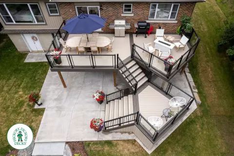 Clubhouse multi level deck with glass railings and lights in Cambridge