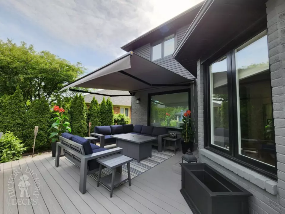 Large grey fiberon deck with a Rolltec awning Large grey fiberon deck with a Rolltec awning