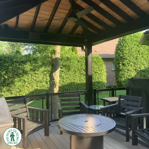 Clubhouse deck in cobblestone with a pavilion, glass railings, lights and a bar seating area, Flamborough, Ontario