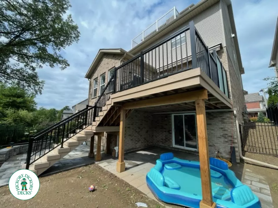 High rise Azek deck in beige color with unique steps and black railing.