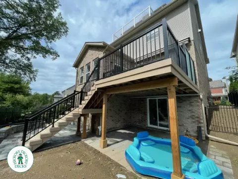 High rise Azek deck in beige color with unique steps and black railing.