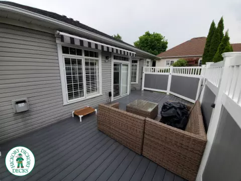 Private grey walk out deck with grey privacy screen all around