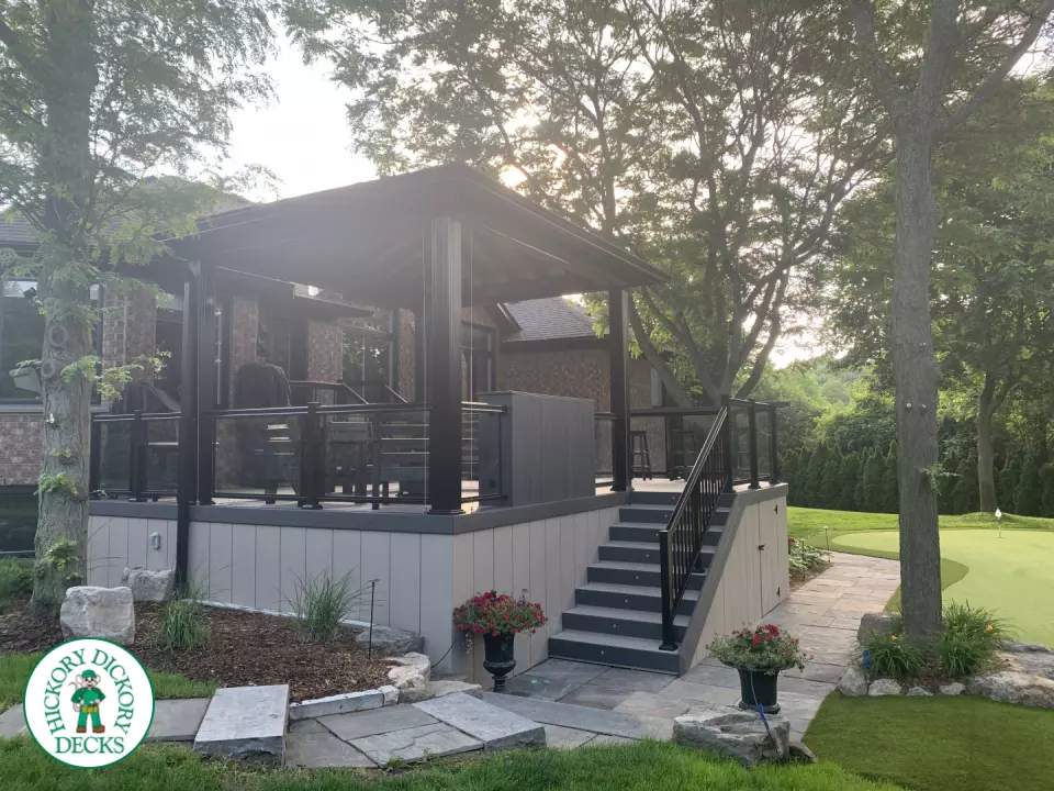 Clubhouse deck in cobblestone with a pavilion, glass railings, lights and a bar seating area, Flamborough, Ontario
