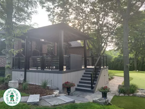 Clubhouse deck in cobblestone with a pavilion, glass railings, lights and a bar seating area, Flamborough, Ontario