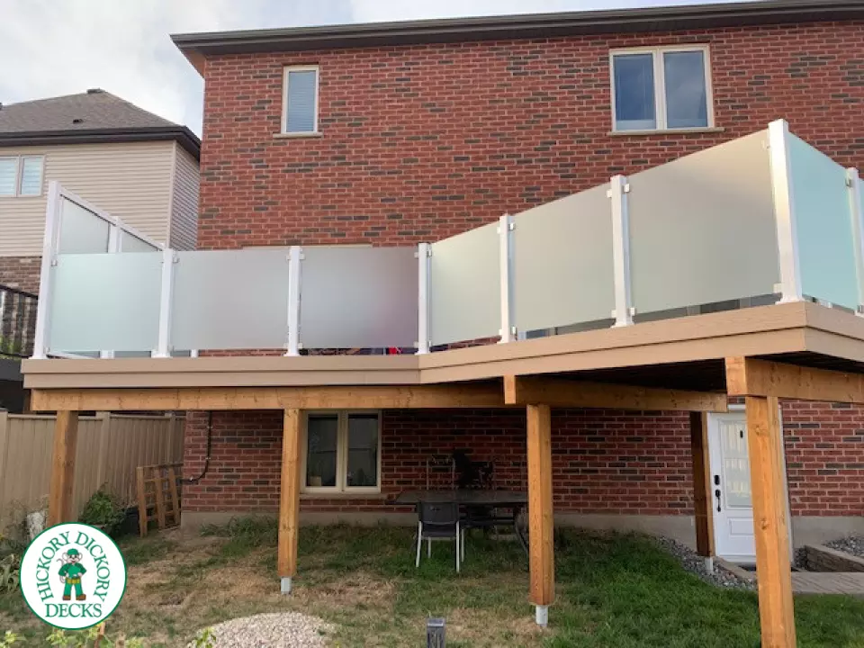 Large high Azek deck with frosted glass privacy screen.