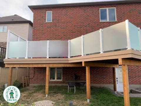 Large high Azek deck with frosted glass privacy screen.