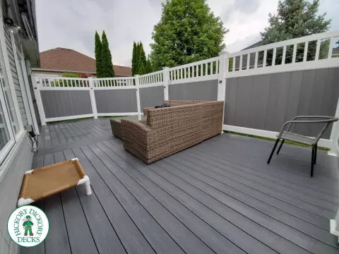 Private grey walk out deck with grey privacy screen all around
