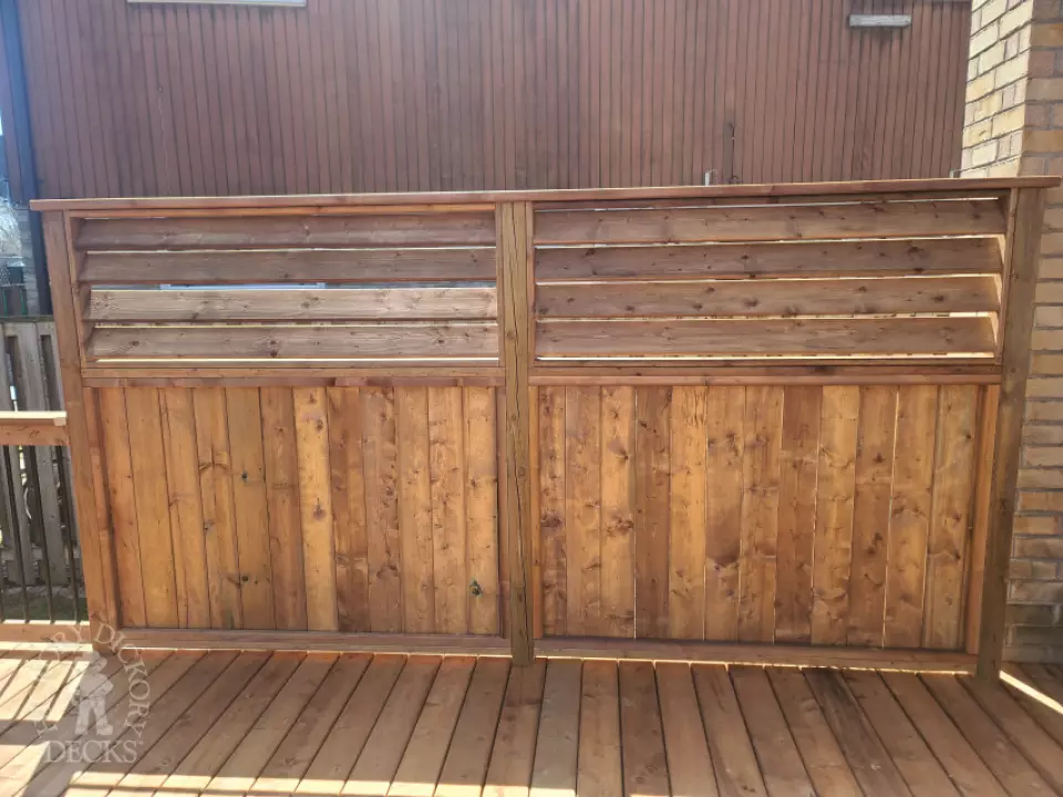 Low cedar deck with picket cedar railings and a cedar privacy screen.