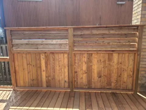 Low cedar deck with picket cedar railings and a cedar privacy screen.