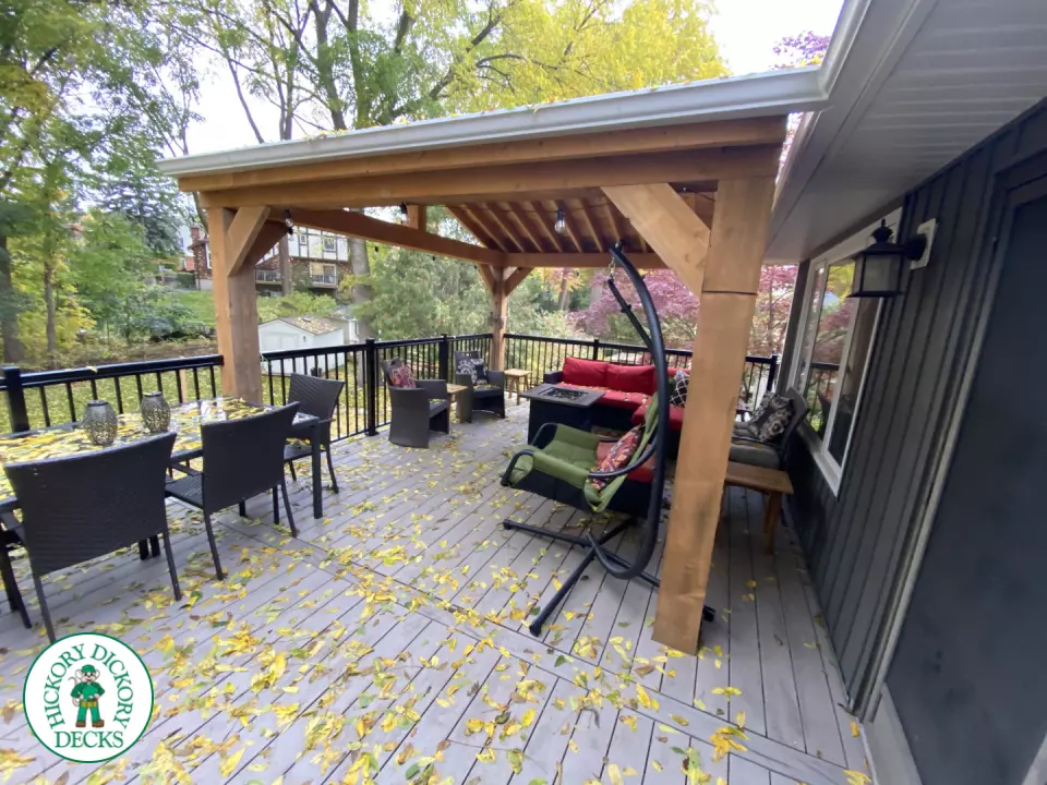 Mid-high deck brown TruNorth deck with lighting in steps and black aluminum railing all around.