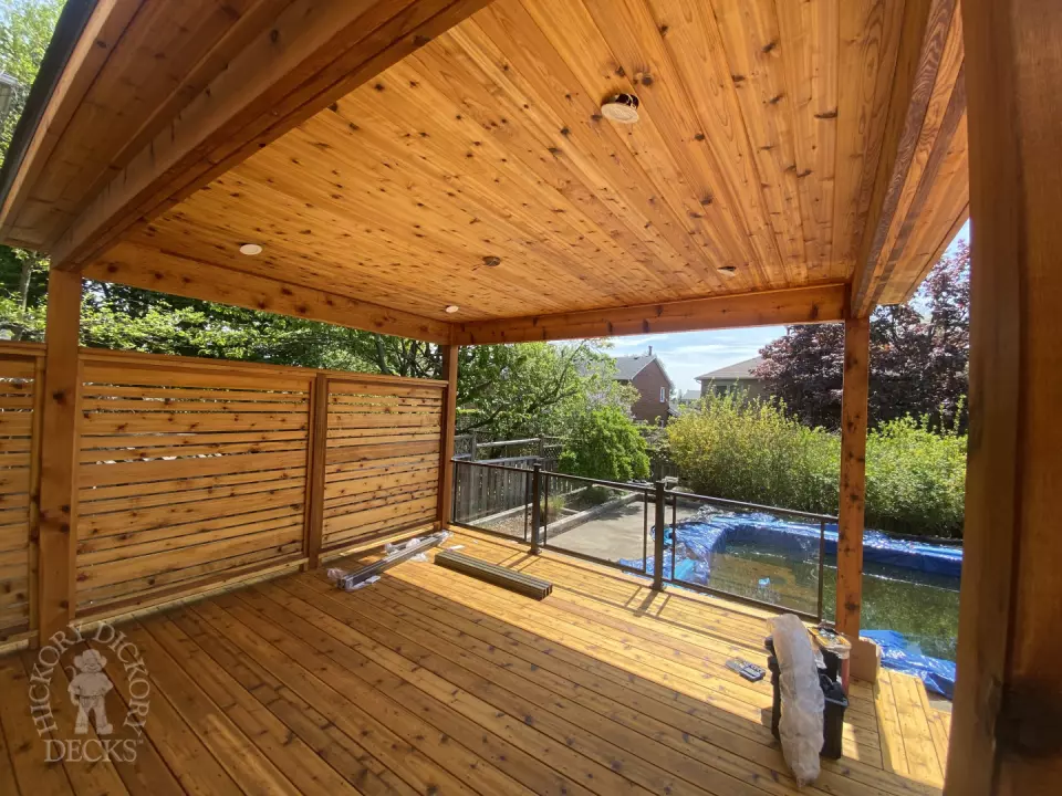 Cedar deck with privacy screens and pavilion in Oakville