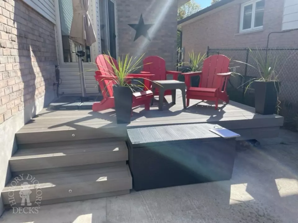 Small grey azek walk out deck with lighting in stairs