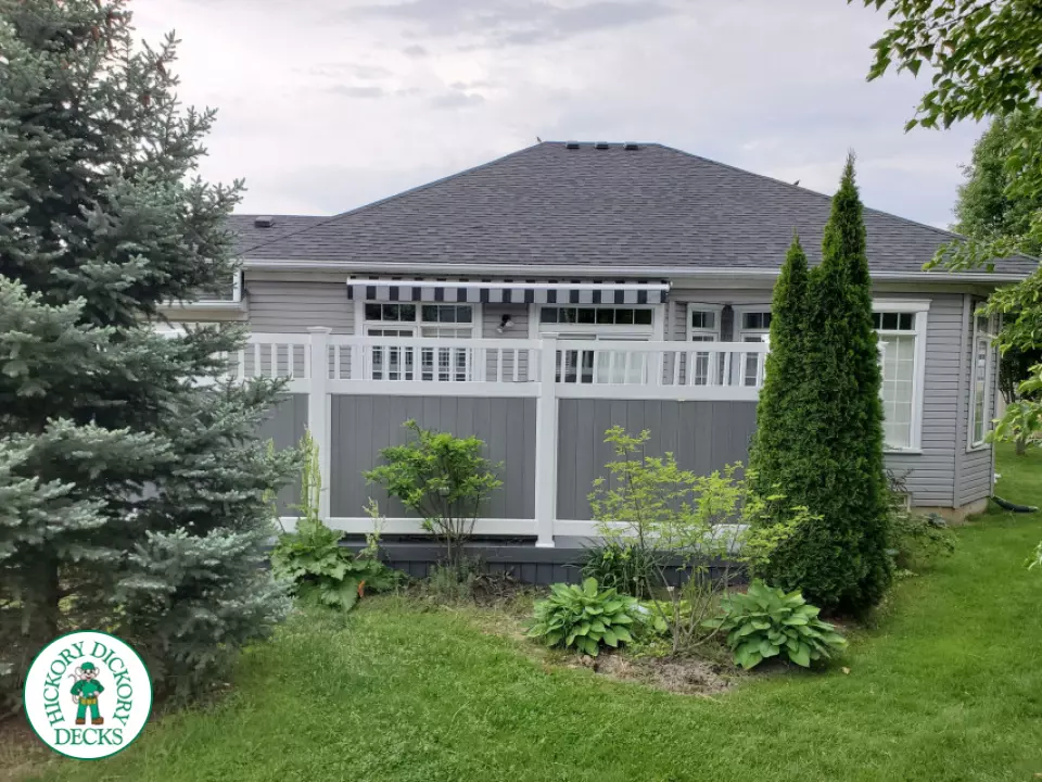 Private grey walk out deck with grey privacy screen all around